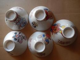 子供茶碗5個セット ロボタン　ウメ星デンカ　怪物くん　ピュー太　トッポ・ジージョ　昭和レトロ　

藤子不二雄『ウメ星デンカ』、藤子不二雄名義で発表されたギャグ漫画・SF漫画、また同作を原作としたアニメ作品。1968年から1970年まで雑誌連載、1969年にテレビアニメ化。アニメ化された当時の品です。 

『怪物くん』は、藤子不二雄名義で発表された日本のギャグ漫画作品。1965年の初出時から安孫子素雄の単独執筆作品。 1968年にはモノクロテレビアニメ。

ピュー太　原案：ムロタニ・ツネ象構成：斎藤賢、光延博愛、永沢詢作画監督：小華和。ためお頭にショックを受けると素晴らしい発明がひらめくというツルリ研究所のツルリ博士の孫・ピュー太が、博士と共にさまざまなメカを開発し、その発明を妨害したり悪用しようとする天才科学者・ワルサ―7世とその助手・ブレーキたちと繰り広げるドタバタギャグアニメーション。その息をもつかせぬめまぐるしい展開とストーリーは、今見ても飽きさせない時代を先取りした傑作。

トッポ・ジージョ（Toppo Gigio）は、マリア・ペレーゴ原作のイタリア生まれのネズミの男の子のキャラクター。大きな耳とブロンドの髪が特徴で、1960年代に人形劇で世界的人気を博しました。