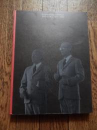 ギルバート＆ジョージ展目録/GILBERT AND GEORGE: ART FOR ALL 1971-1996.現代イギリス美術界の異才
 出版社 セゾン美術館/Sezon Museum of Art
刊行年 1997
ページ数 189 with numerous col. and monochro. illus.
サイズ 25 x 19/Printed boards 
ギルバート・プロッシュ（Gilbert Prousch、イタリア出身、1943年9月17日 - ）とジョージ・パサモア（George Passmore、イギリス出身、1942年1月8日 - ）の二人組であり、常にペアで創作活動をしているため、"ギルバート&ジョージ"として知られている。風変わりで時に攻撃的な作品から、常に物議を醸している現代美術家である。

ギルバートはイタリアのボルツァーノ自治県サン・マルティーノ・イン・バディーア出身で、オーストリアとミュンヘンでアートを学んだ後にイギリスに渡った。ジョージはイングランドのプリマス生まれ。二人はロンドン芸術大学のセントラル・セント・マーチンズで彫刻を学んでいる時に出会った。二人はゲイのカップルだと言われているが、プライベートは明かさないので定かではない。

ジョージ&ギルバートはパフォーマンス・アーティストとして知られている。彼らの学生時代の作品として"The Singing Sculpture"（歌う彫刻）があるが、これは自分自身を金箔で覆い、Flanagan and Allenの曲に合わせて何時間もテーブルの上でマイムをするというものであった。ギルバートとジョージはパフォーマンスなど作品発表や公衆の場に現れる際はいつも同じようなビジネス・スーツを着て、ほとんどいつも二人一緒に行動している。スーツはイギリス人らしさであると同時に、普通の人の普通の生活の象徴でもある。2人のすることはすべてアートだという事で、自分自身を生きる彫刻、"living sculptures"と称している
