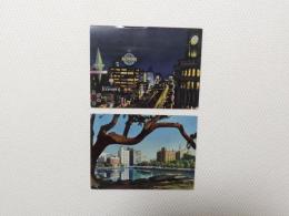 1000490■戦前 絵葉書■丸の内ビルの一角　夜の銀座 (建物　ネオン　看板チョコレート)2枚